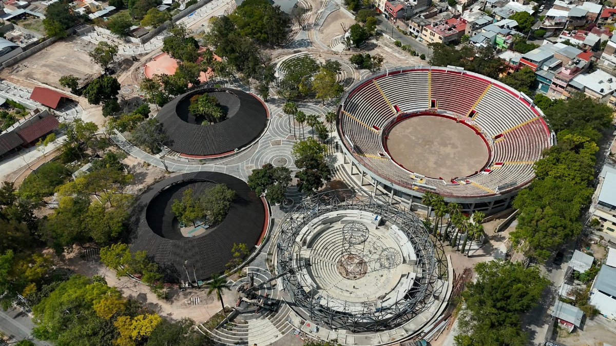 Aerial shot of sports complex in Chilpancingo showing large circular arenas surrounded by trees.