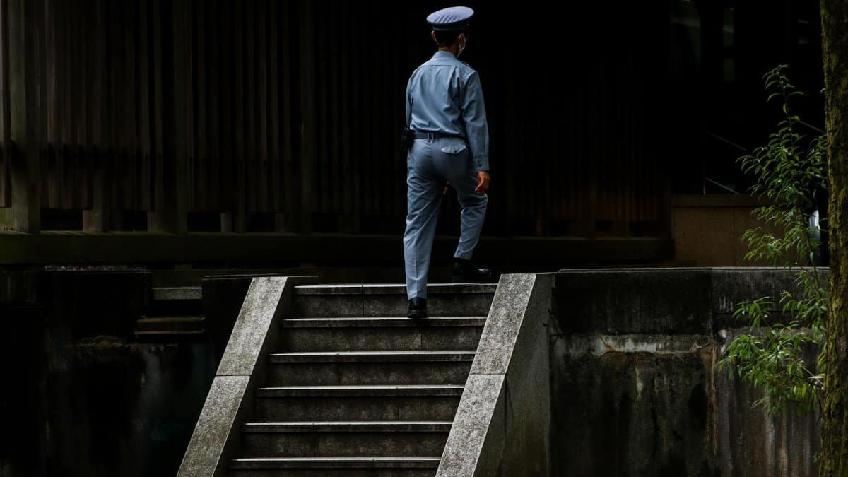 A security officer in uniform ascends steps, showcasing professionalism and duty.
