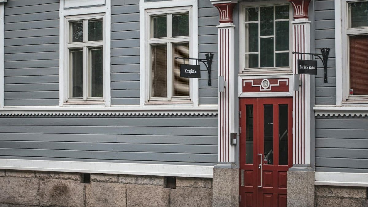 Vintage building facade with red door in Tampere, Finland. Classic Nordic architecture.