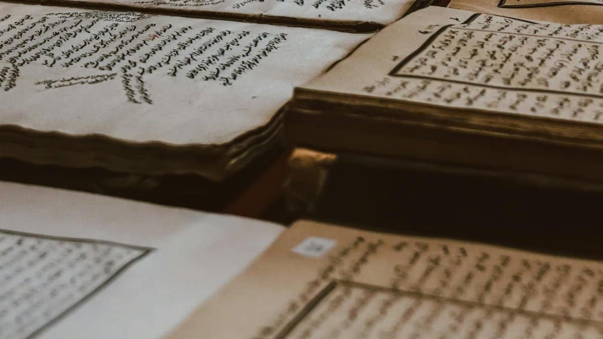 A collection of ancient manuscripts featuring Arabic script, showcasing historical texts on aged paper.