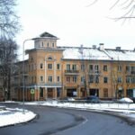Snow-covered street in Narva, Estonia, featuring historic buildings and urban winter scenery.