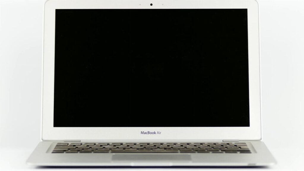 Front view of a MacBook Air laptop with a blank screen on a white background.