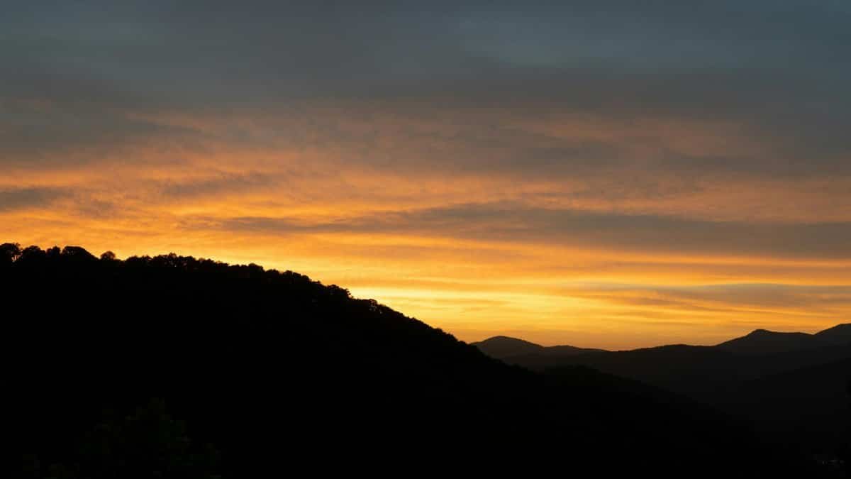 Stunning sunset with glowing skies over the Blue Ridge Mountains, Asheville, North Carolina.
