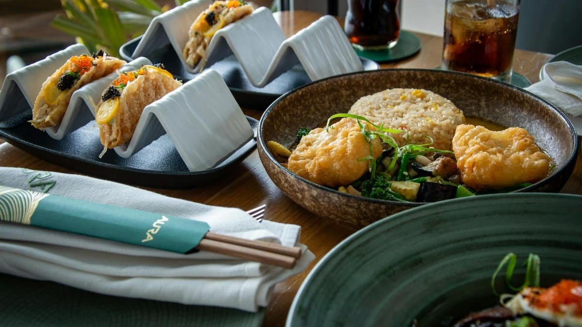 Asian fusion dishes with tacos and fried rice elegantly presented in a modern restaurant setting.