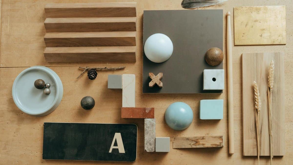 Creative flat lay featuring wooden pieces, geometric shapes, and natural elements on a table.