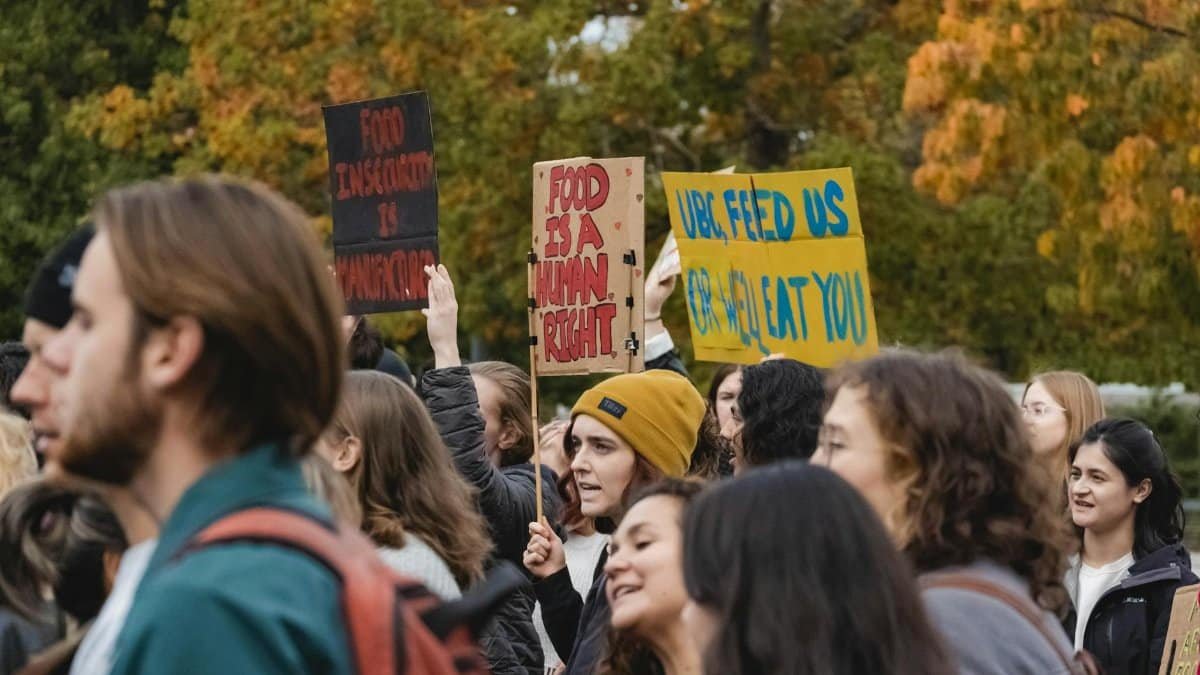 Protesters in Vancouver holding signs advocating for food security and human rights.
