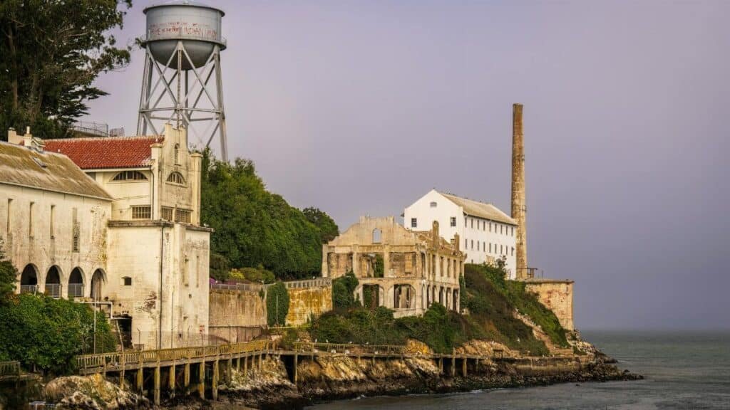 View of Alcatraz Island's historic ruins and water tower in San Francisco Bay.