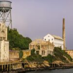 View of Alcatraz Island's historic ruins and water tower in San Francisco Bay.