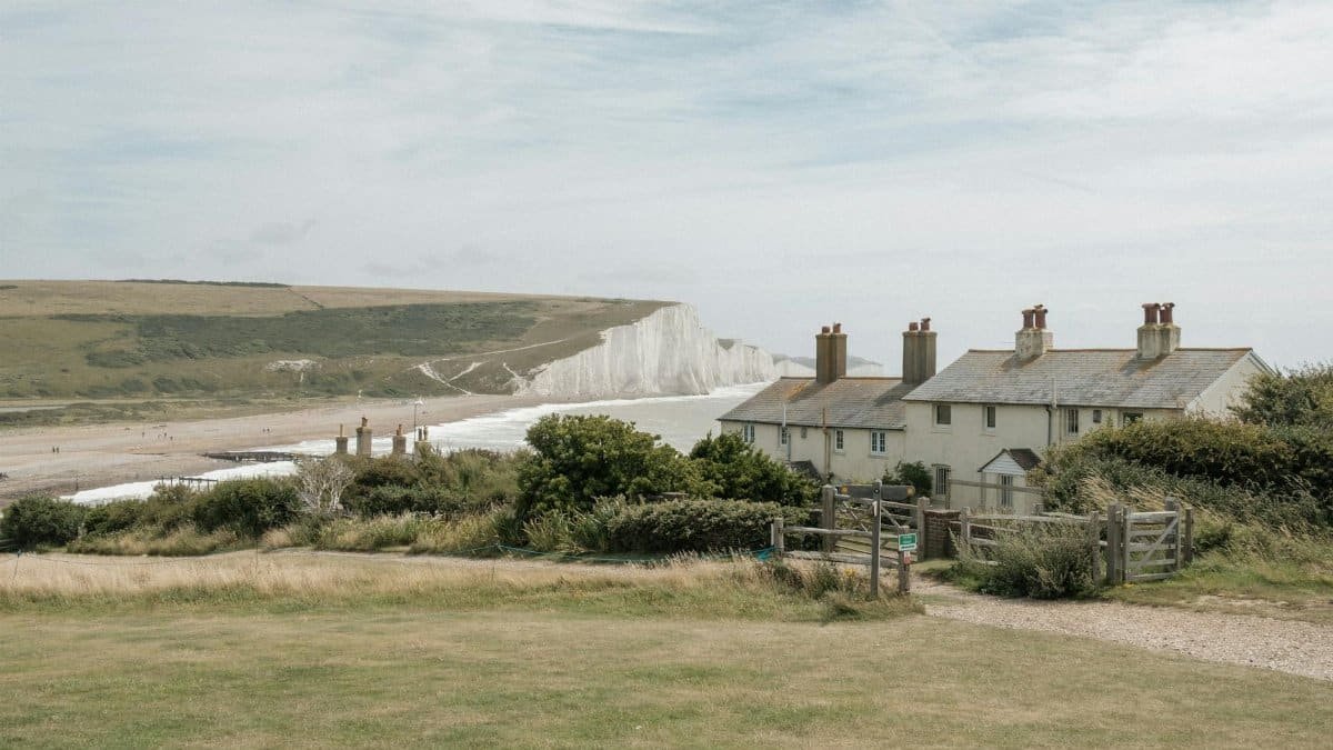 Idyllic scene of coastal cottages at the Seven Sisters cliffs, England.