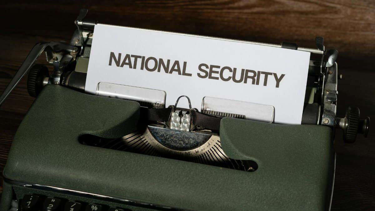Close-up of a vintage typewriter with a paper showing the words 'National Security.'