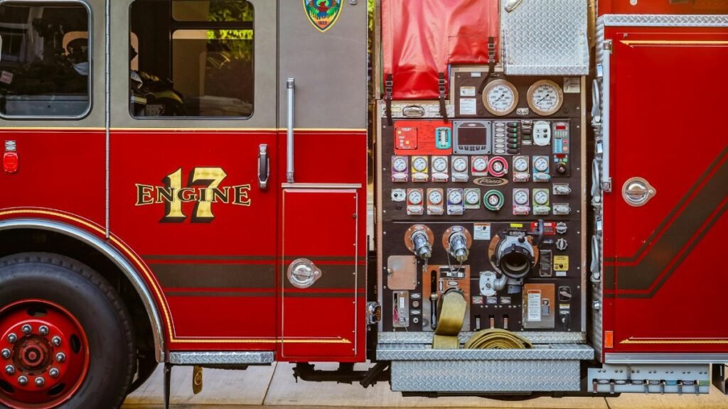 Detailed view of a fire truck's control panel and side compartment with equipment.