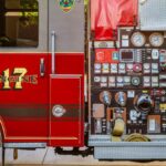 Detailed view of a fire truck's control panel and side compartment with equipment.