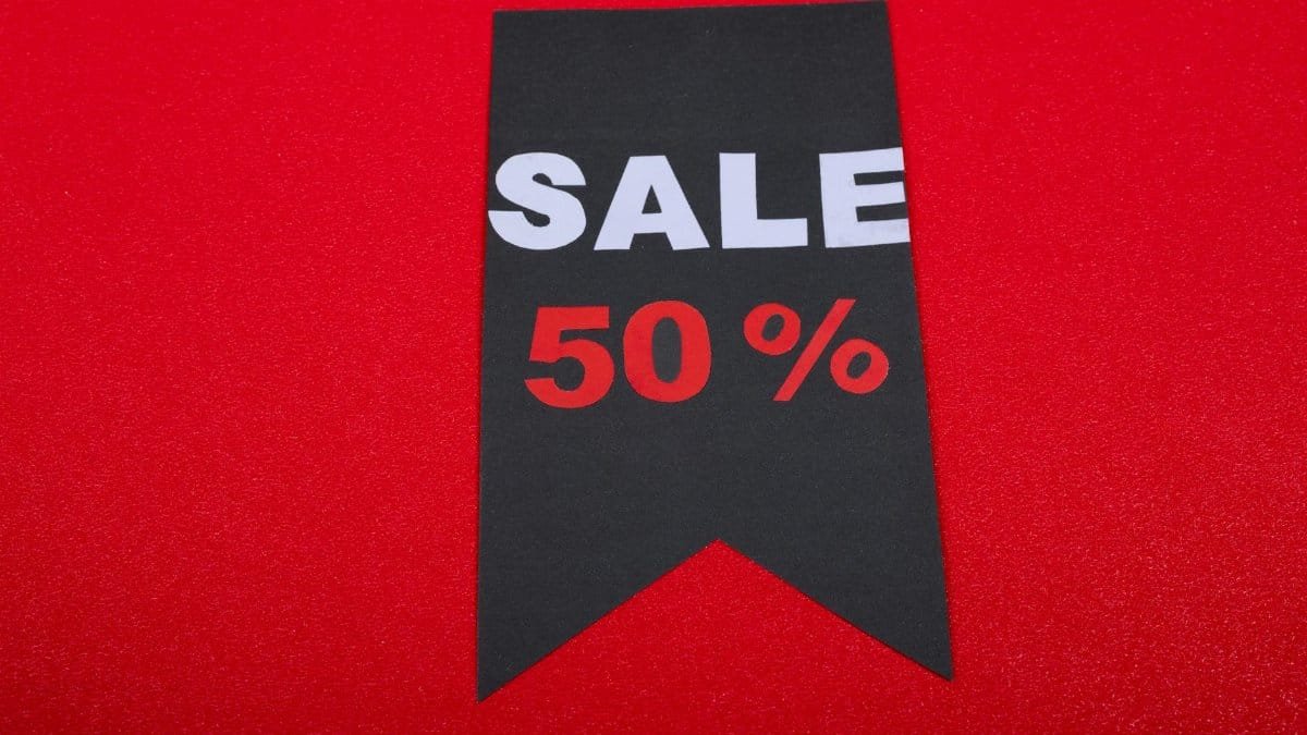 Modern sale tag offering 50% discount on vibrant red background.
