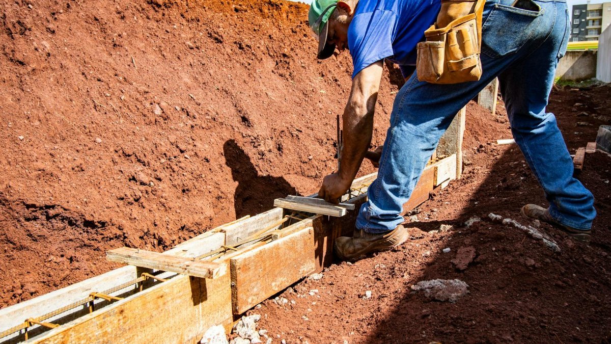 Male construction worker building a foundation outdoors in Londrina, Brazil.