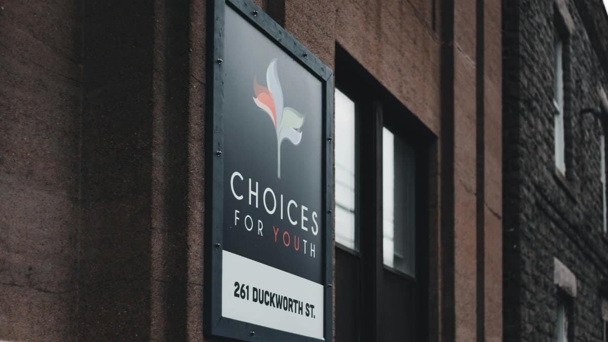 Close-up of Choices for Youth sign on urban building at 261 Duckworth St.