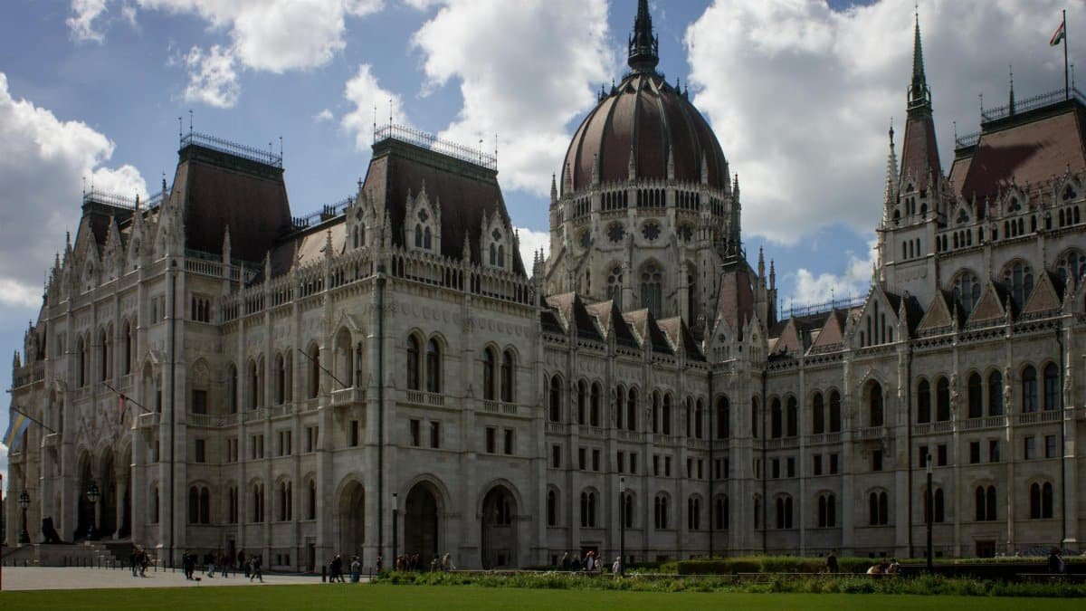 The iconic Hungarian Parliament Building in Budapest under a clear blue sky.