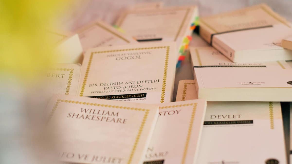 A collection of classic literature books laid out on a table.