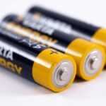 High-quality image showcasing a close-up view of three alkaline batteries on a white surface.