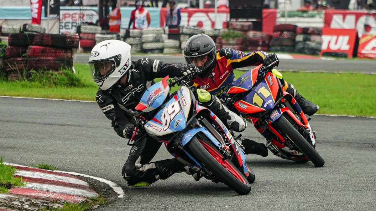 Intense motorcycle race on a circuit in Tarlac City, featuring skilled riders in action.