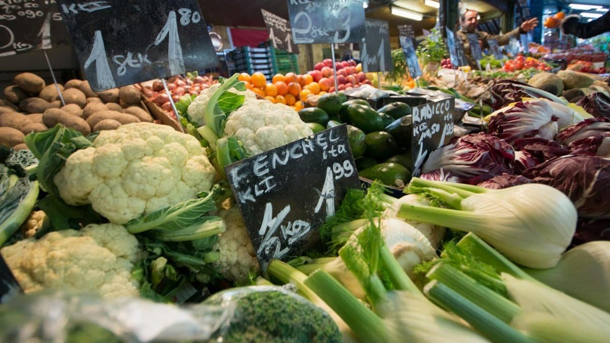 A vibrant display of fresh vegetables at a local market stall, showcasing a variety of produce.