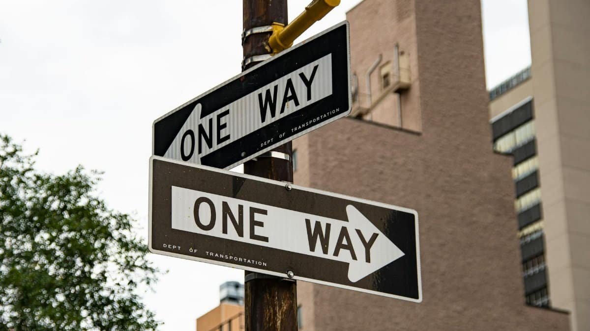 Close-up of one way street signs in urban New York City setting.