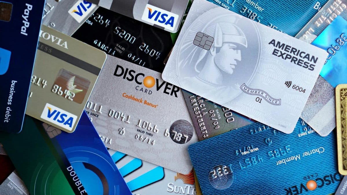Close-up image of various credit cards including Visa, Mastercard, and American Express.