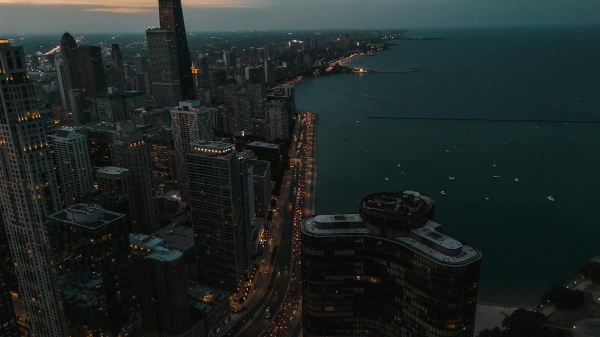 A stunning aerial view of Chicago's skyline and Lake Michigan during twilight, showcasing the city's architecture.