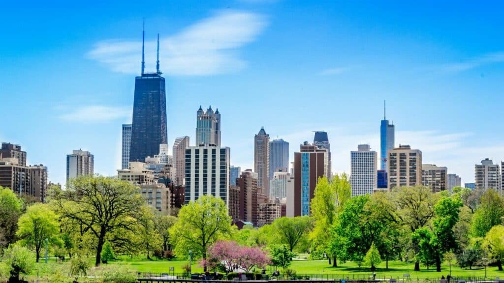 Vibrant Chicago skyline featuring the John Hancock Center and lush park foreground.