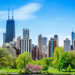 Vibrant Chicago skyline featuring the John Hancock Center and lush park foreground.