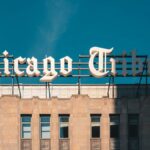 Close-up of Chicago Tribune Building architecture under a clear blue sky.