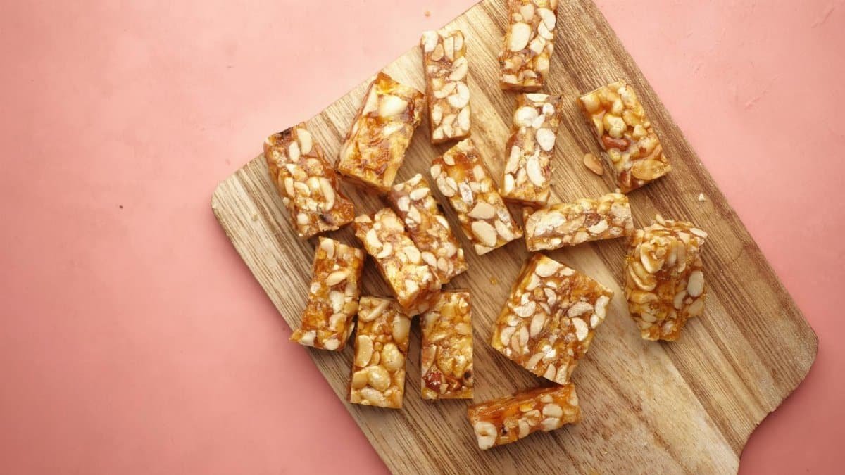 Wooden cutting board displaying tasty homemade nut bars, ready to eat.