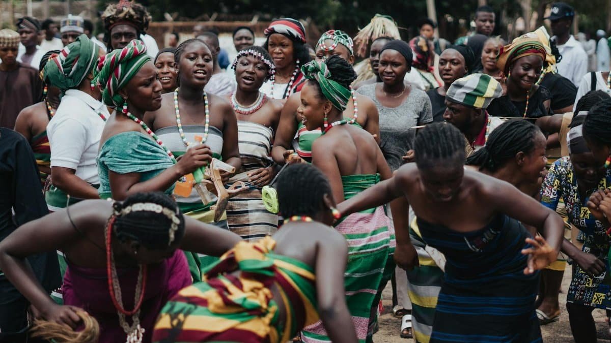 Vibrant traditional dance with people wearing colorful attire in an outdoor setting.