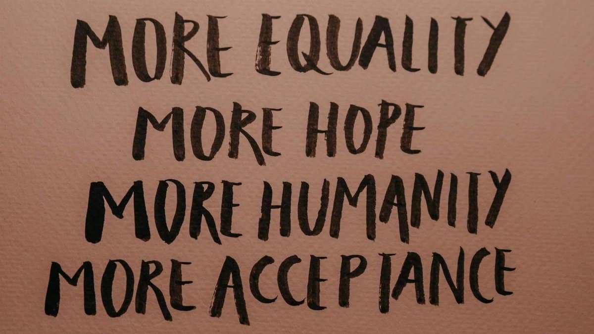 Handwritten motivational phrases promoting equality, humanity, hope, and acceptance.