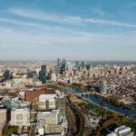 High-angle aerial view of Philadelphia showcasing the cityscape and skyline under a clear blue sky.