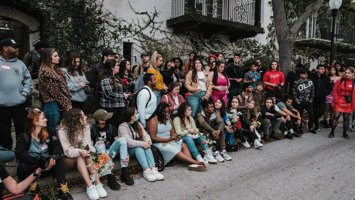 A large, diverse group of people gathered outdoors in Orlando for a community event.
