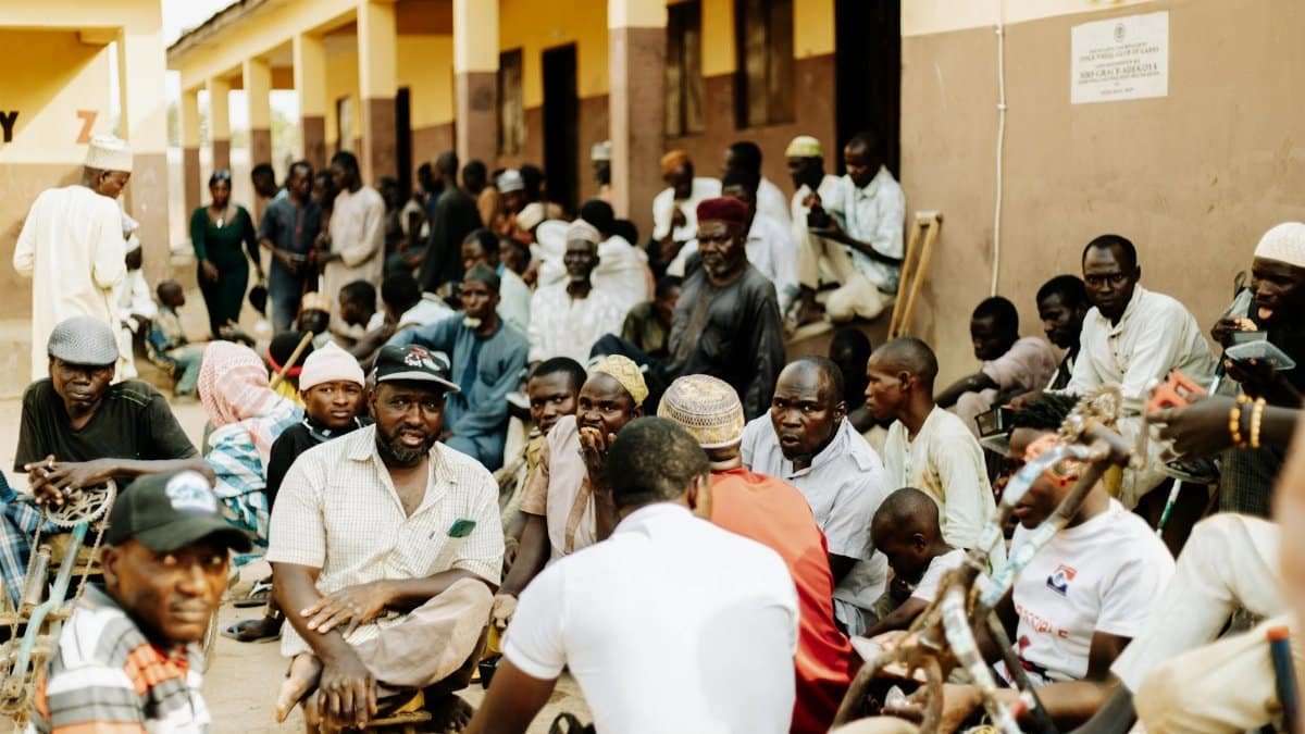 A bustling outdoor meeting with diverse group at a community center