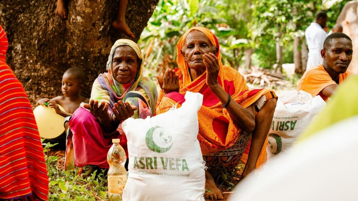People gathered outdoors for food distribution, showcasing community support and aid.