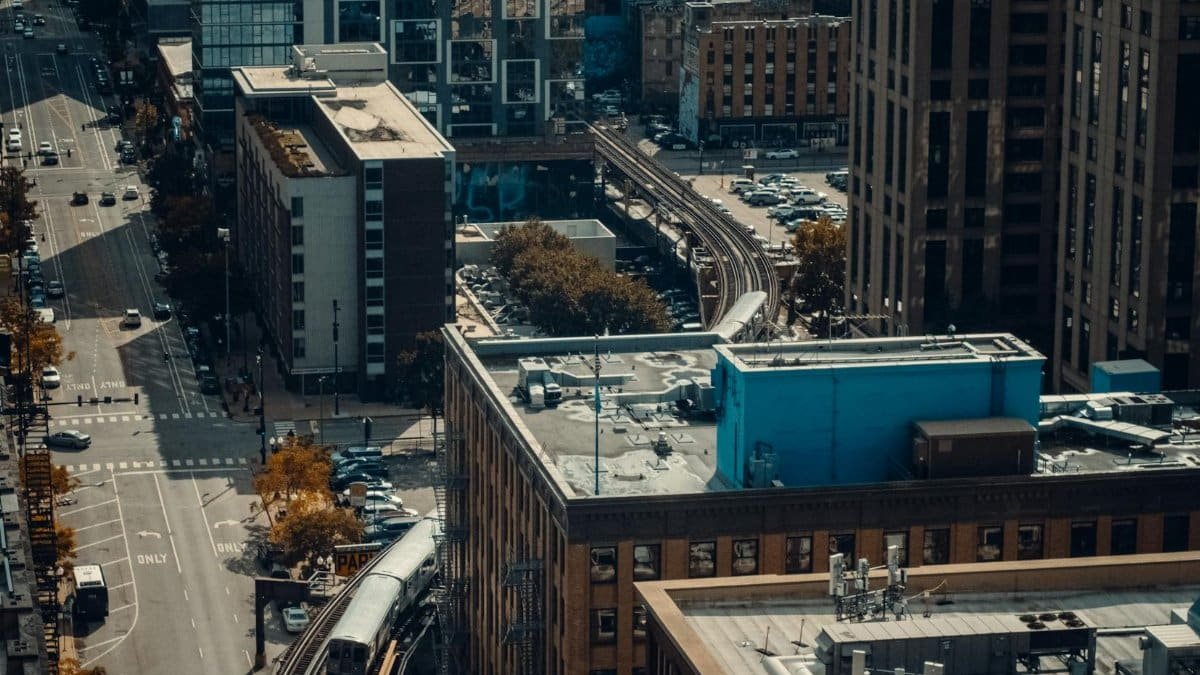 Aerial view of Chicago's downtown with buildings, streets, and elevated train tracks.