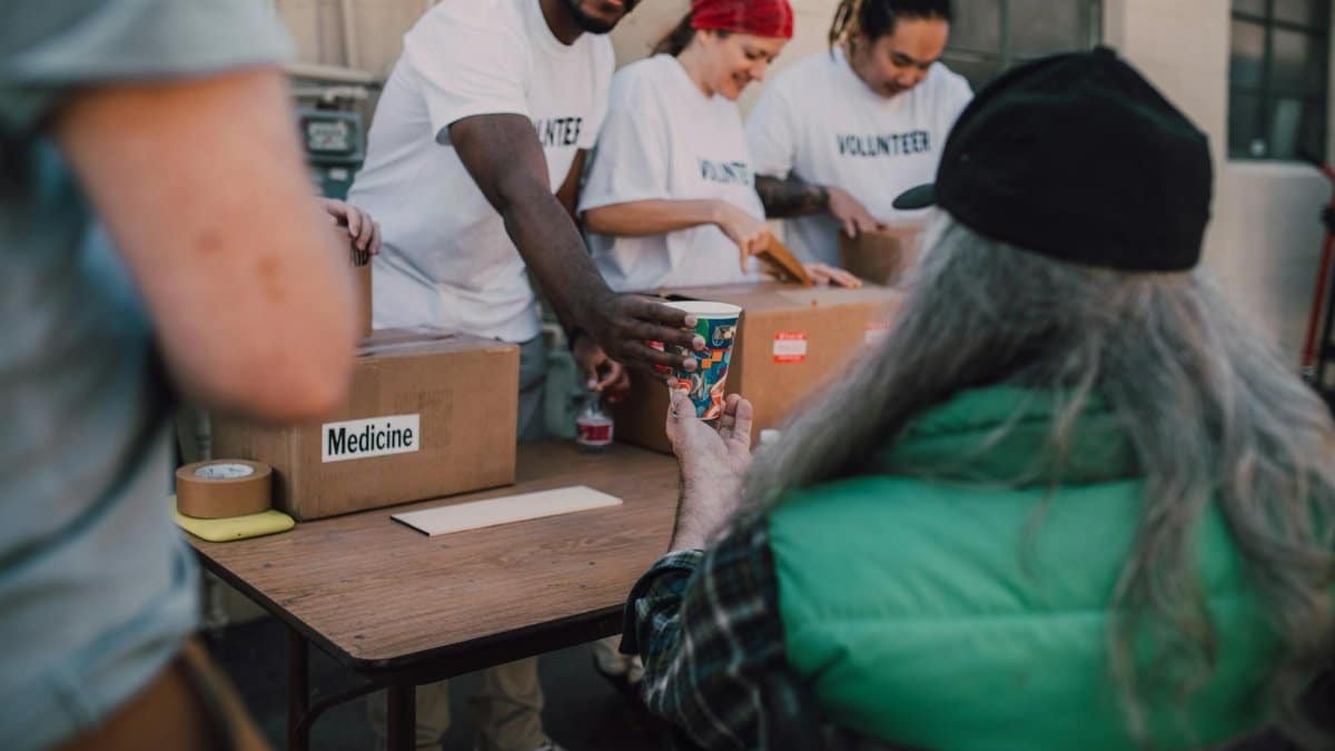 Volunteers handing out donations and support to those in need at a community event.