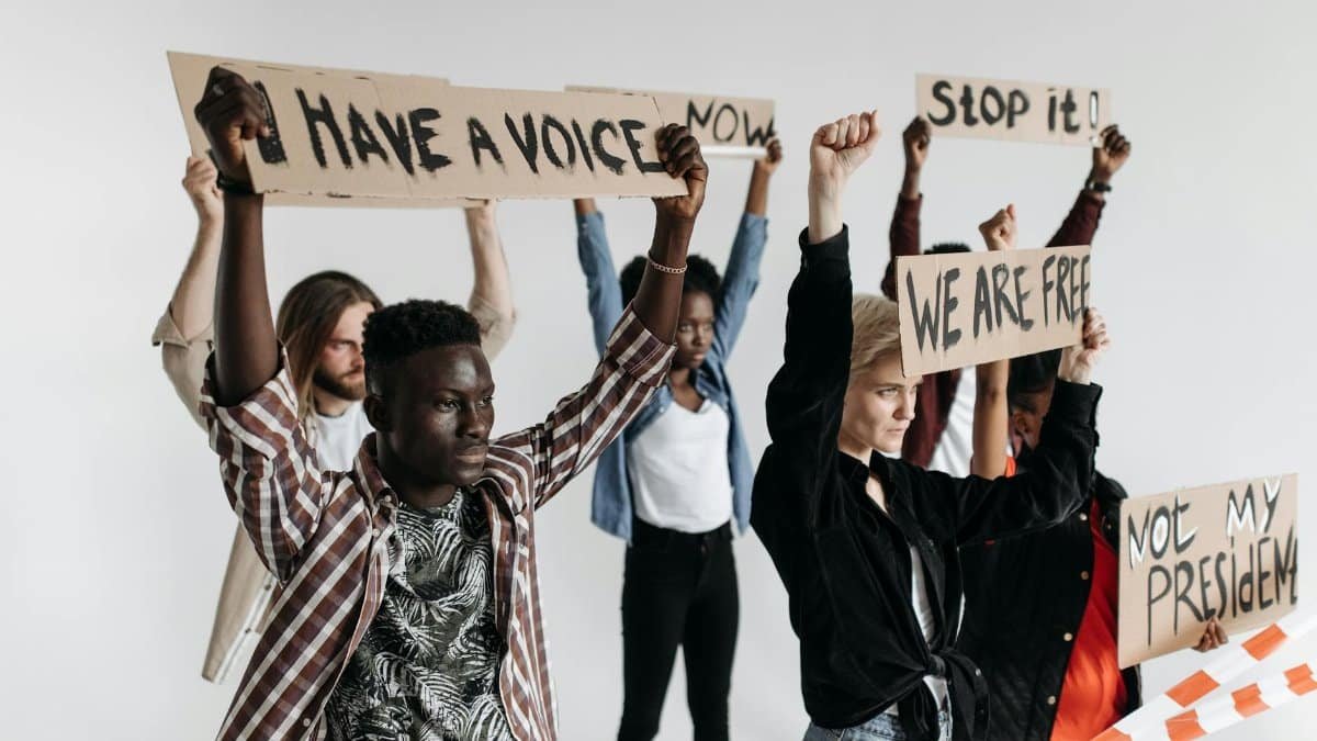 Protesters holding placards advocating freedom and equality.