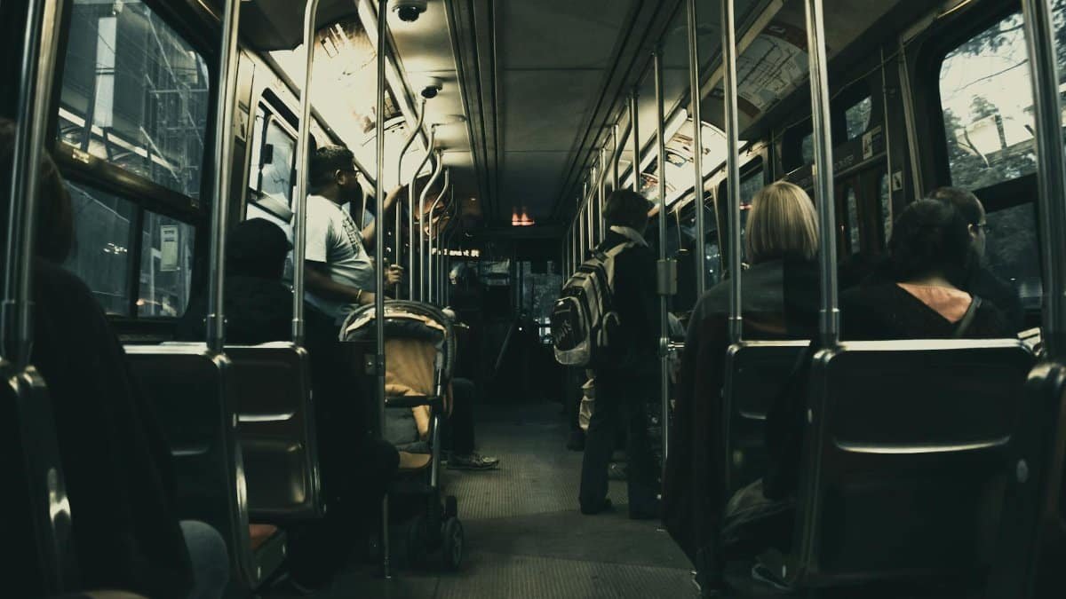 Passengers riding a city bus at night, showcasing urban commute and public transport.