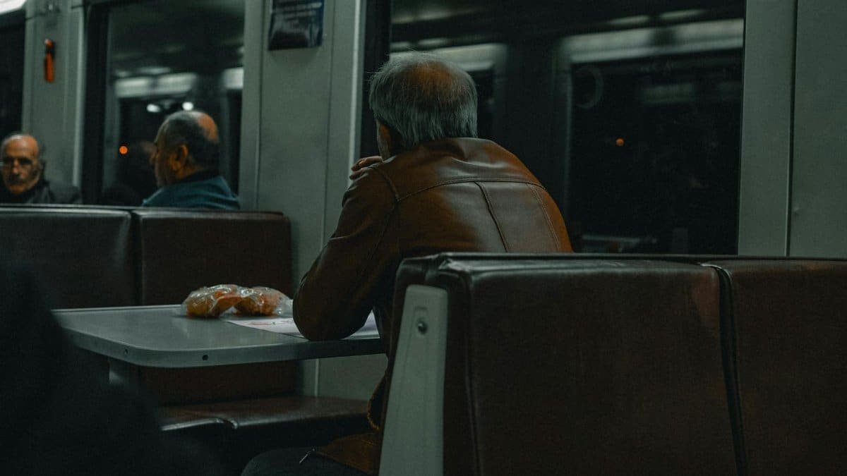 Seniors engaged in quiet travel on a nighttime train in Ankara, Türkiye.