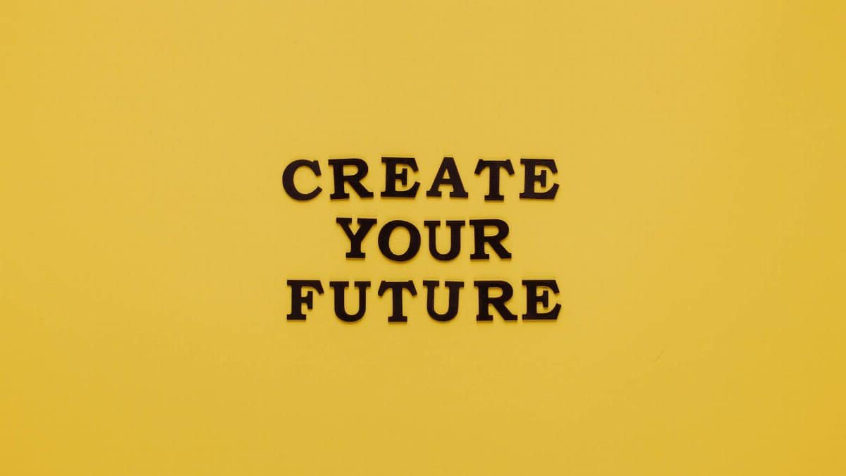 Bold text 'CREATE YOUR FUTURE' on minimalist yellow background. Inspiring design.
