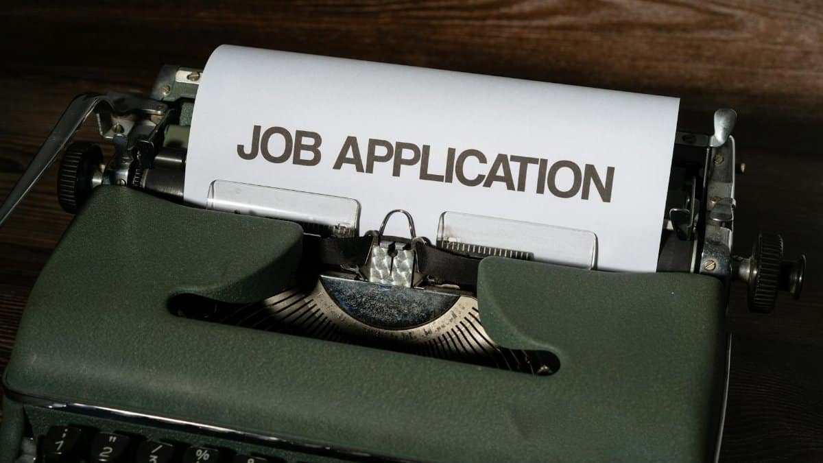 Close-up of a vintage typewriter with a job application paper inserted.
