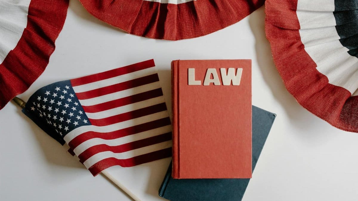 American flag with a law book, symbolizing independence and politics.
