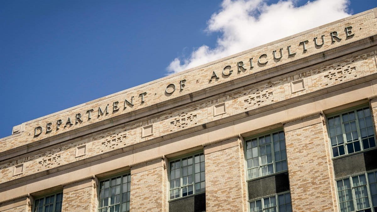 Close-up of the Department of Agriculture building facade under a clear blue sky.