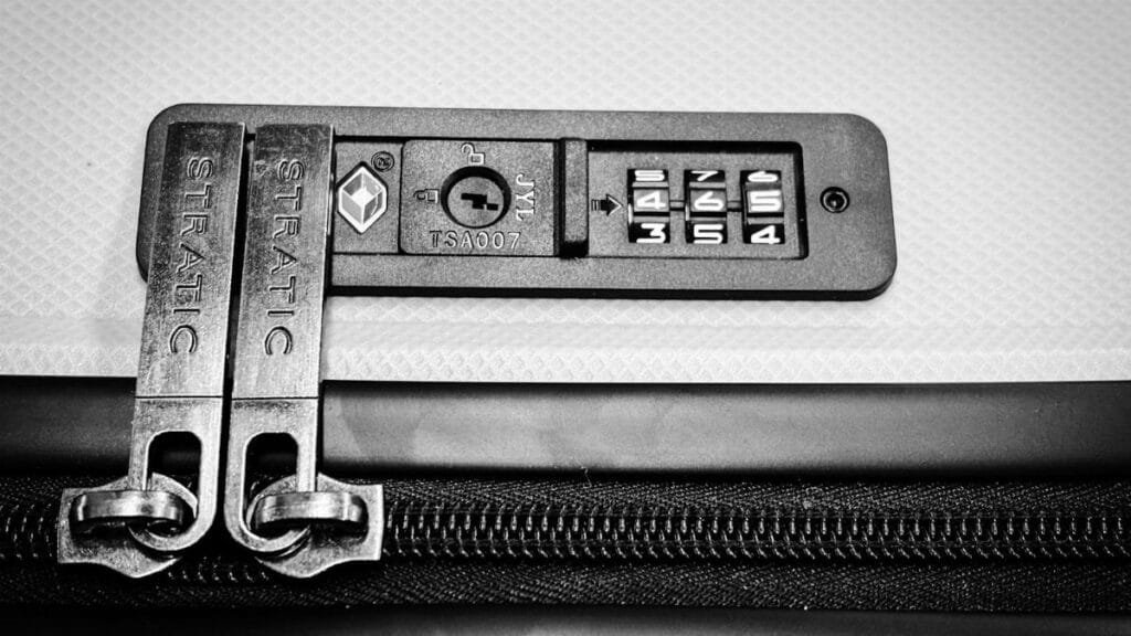 Close-up image of a TSA-compatible zipper lock on a suitcase, ensuring travel security.