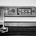 Close-up image of a TSA-compatible zipper lock on a suitcase, ensuring travel security.