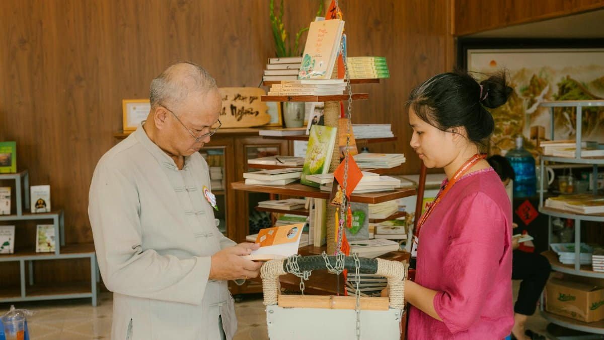 Two people examining books in a cozy indoor setting, suggesting learning or relaxation.