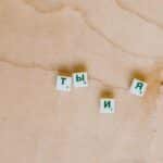 Cyrillic Scrabble tiles arranged on a wooden surface showcasing Russian text.